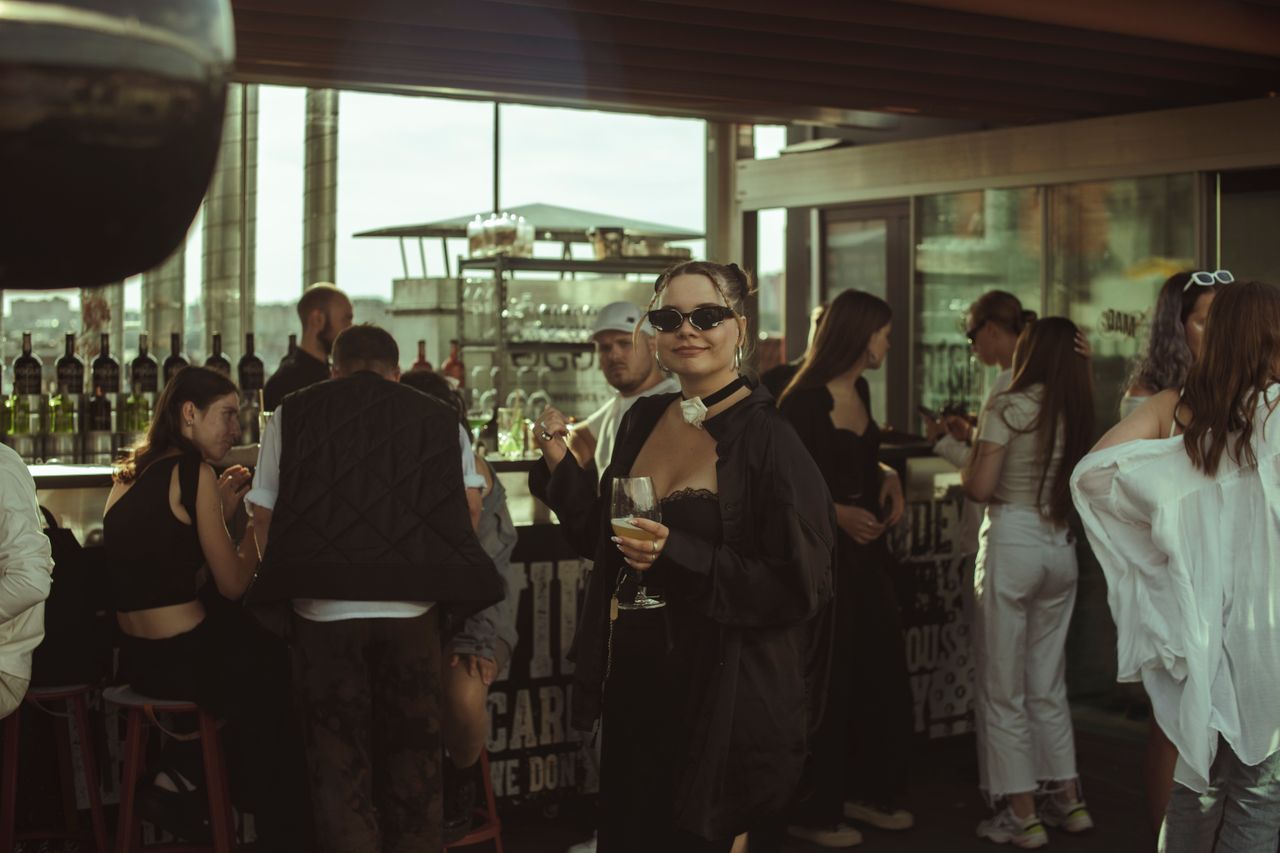 Friends sharing a laugh at a golden-hour rooftop gathering